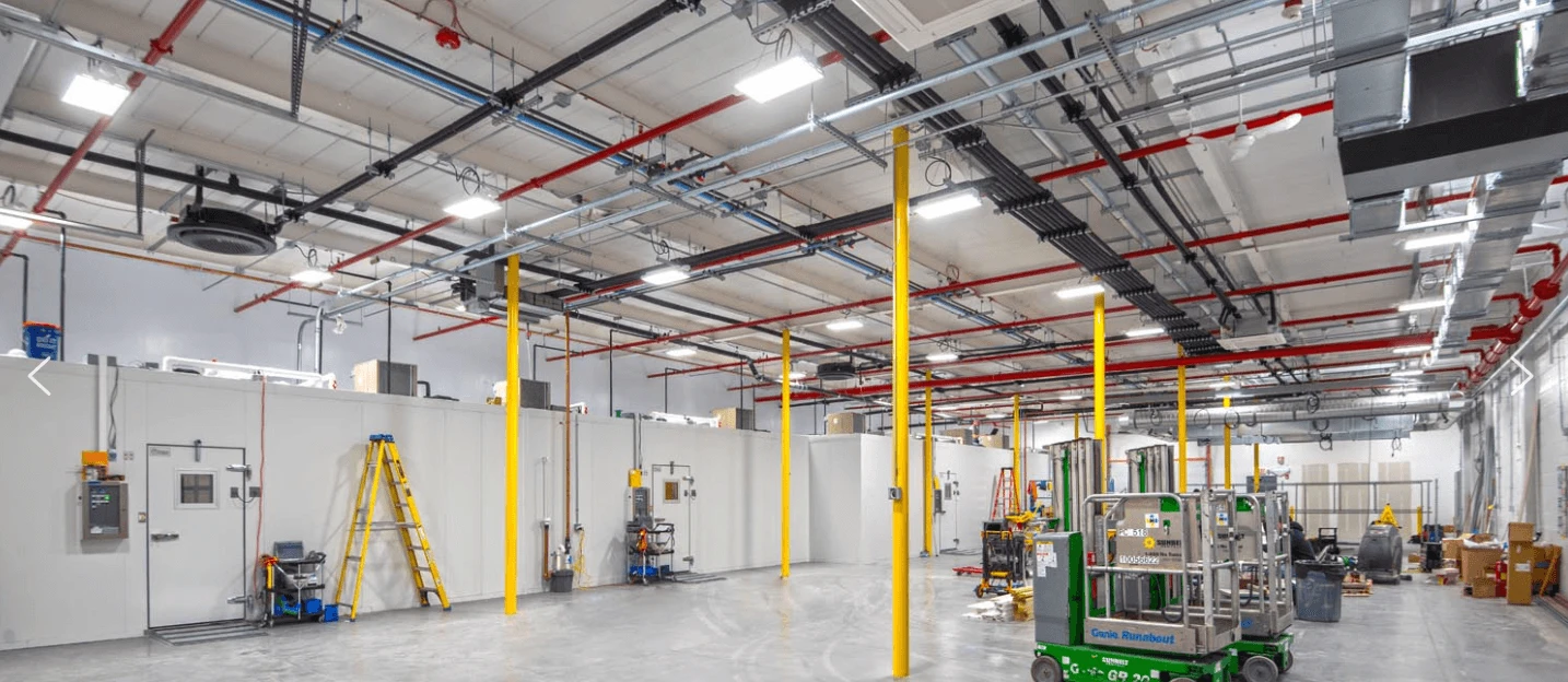 The inside of a large warehouse with a lot of equipment.