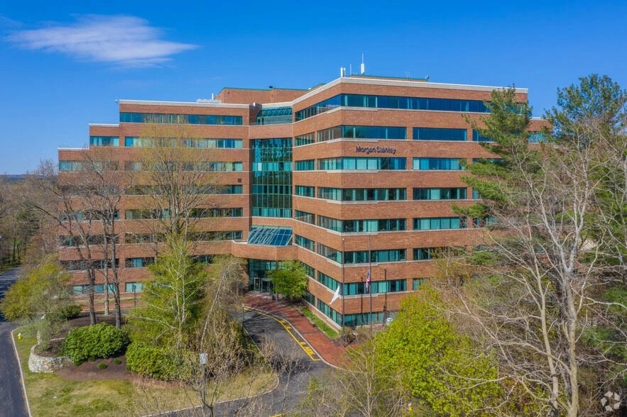 An aerial view of an office building surrounded by trees.