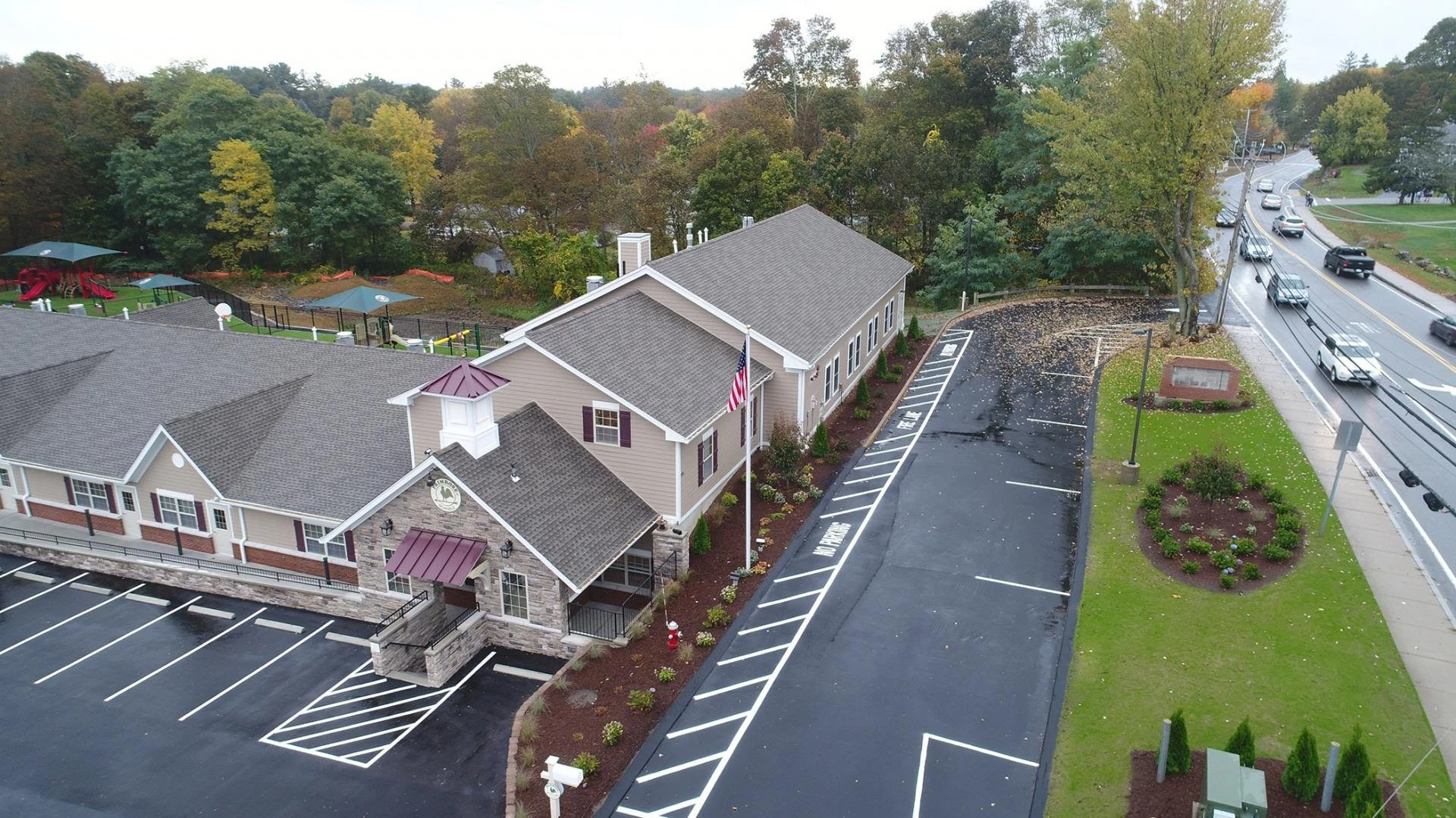 An aerial view of a motel in a parking lot.