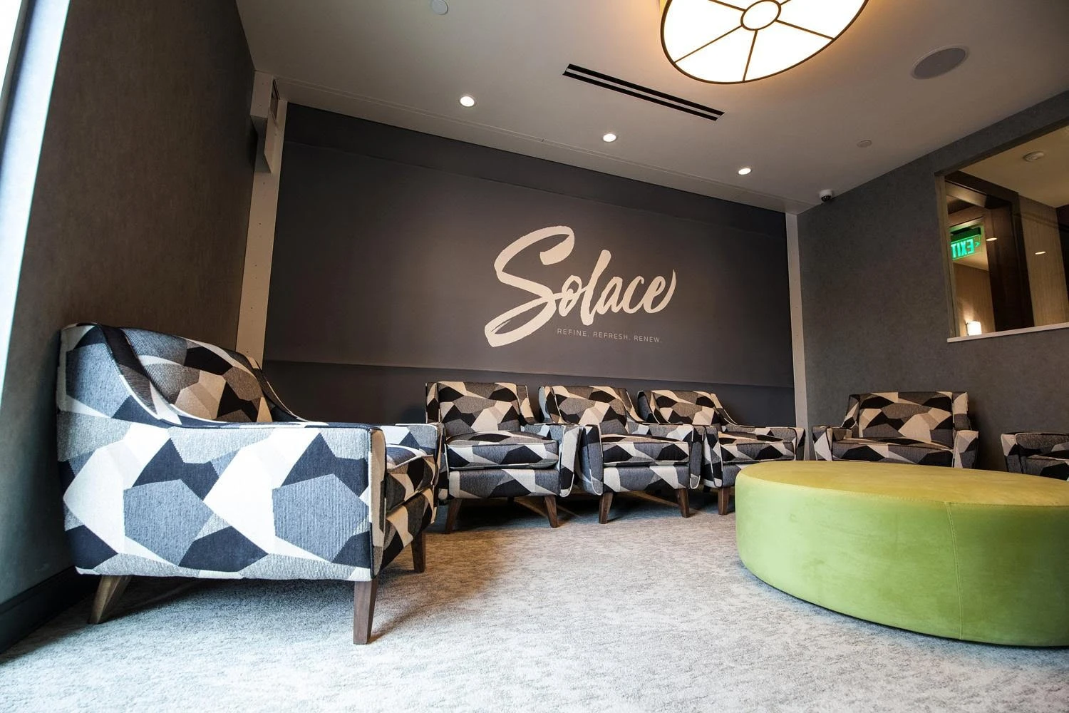 A reception area with chairs and a sign that says soha.